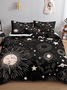 a black and white bed with stars and planets on it