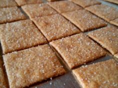 crackers cut into squares on a cutting board