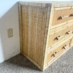 a wicker dresser with four drawers on the bottom and one drawer at the top