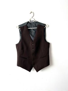 "Vintage Small size formal mens vest Groom waistcoat button down fitted waistcoat Brown classic vest Office mens vest Estimated size: S Measurements: (lying flat) Length - 22.5\"/ 57 cm Pit to pit: 19\"/ 48cm Waist - 17\"/ 43 cm Please check measurements to insure a proper fit. Remember to allow yourself some extra room for movement. You can compare these with something from your closet that fits you well. This vest will come to you freshly laundered and ready to wear. Please feel free contact me if you need additional measurements or have any questions Condition: great vintage condition SHIPPING * I ship worldwide via Priority mail (Latvijas Pasts) from Latvia (EU). * I ship from Europe, so please allow 2 to 4 weeks for the package to arrive if you live overseas. * Europe 5 - 10 business Formal Winter Sleeveless Vest, Business Sleeveless Vest With Buttons, Semi-formal Sleeveless Vest With Button Closure, Sleeveless Business Vest With Buttons, Formal Sleeveless Winter Vest, Business Vest With Single Button, Business Vest With Single Button Sleeveless, Formal Sleeveless Vest With Button Closure, Business Sleeveless Vest With Single Button