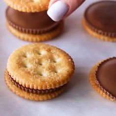 a person picking up some cookies from a tray