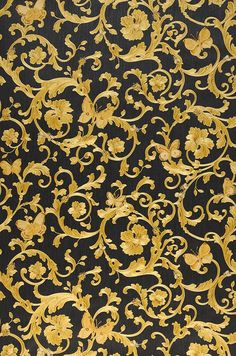 a black and yellow wallpaper with gold swirls