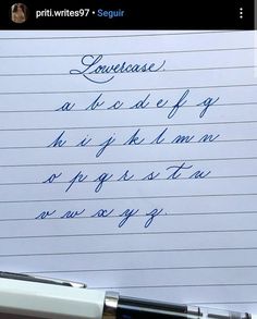 a handwritten note on top of a white piece of paper with blue ink in cursive writing