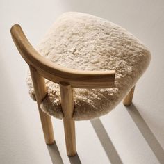 Inspired by modern Parisian apartments, the Perle natural shearling dining chair by goop is a sleek take on a classic silhouette with its deep, armless profile, vertical lines and contoured T-back. Soft, tactile shearling provides an elegant counterpoint to the lightly wirebrushed and cerused American white oak certified sustainable by the Forest Stewardship Council r FSC, while an unlacquered brass andamp;quot;gandamp;quot; medallion on the front leg lends a refined final flourish. Whether in t Shearling Chair, Modern Parisian Apartment, Modern Parisian, Wood Counter Stools, Oak Dining Chairs, Grey Dining, Wood Counter, Vertical Lines, Wood Dining Chairs