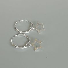 ** Please go through all the pictures i have posted for a listing to get an exact idea of the actual size of the item.A PAIR of sterling silver hoops. Comes with a detachable tiny and delicate star charm.The charm is multipurpose and can be used with a neck or bracelet chain too.Dimension: Hoop- 12 x 1.2 mm   Charm- 6 x 6 mm  Weight: 0.97 gmPrice listed is for a PAIR of hoops.These earrings are made of 925 hypoallergenic sterling silver and comes with a 925 stamp.Can be packaged in a gift box. I Dainty Silver Nickel-free Huggie Earrings, Sterling Silver Star Charm Huggie Earrings, Sterling Silver Star Charm Cartilage Earrings, Sterling Silver Star Cartilage Earrings With Star Charm, Minimalist Sterling Silver Star Charm Earrings, Silver Star-shaped Sterling Silver Hoop Earrings, Dainty Silver Hoop Earrings For Gift, Silver Star Charm Earrings For Everyday, Sterling Silver Hoop Earrings With Star Charm For Gift