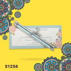 an ornate wedding card and tie on a yellow background