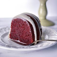 a slice of red velvet cake on a plate with a fork