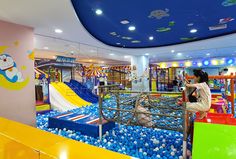 a child's play area in a children's indoor playground with lots of balls and toys