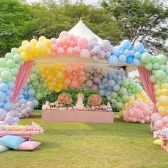 an outdoor party with balloons and decorations