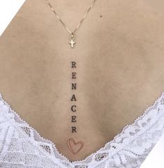 the back of a woman's neck with an inscription on it that says renacer