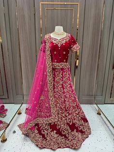 1. Featuring exquisite zardozi, crystal and sequin embroidery, this ombre-pink-maroon velvet lehenga is a stunning selection for the modern bride. 2. Accompanied by a maroon velvet long blouse and a pink net dupatta. 3. Size : 38 / M 4. Ready to ship ! Anarkali Wedding Velvet Lehenga, Anarkali Velvet Lehenga For Wedding, Wedding Velvet Fitted Lehenga, Red Velvet Dupatta For Reception, Red Velvet Wedding Sets, Velvet Lehenga With Sheer Dupatta For Reception, Velvet Choli With Sheer Dupatta For Wedding, Wedding Velvet Choli With Sheer Dupatta, Bollywood Velvet Lehenga For Wedding