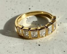 a gold ring with white stones on it