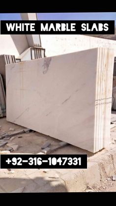 white marble slabs for sale in the middle of a construction area with text overlaying them