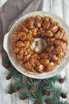 a plate with some food on it next to pine cones