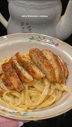 a plate with chicken and pasta on it