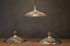 two metal lamps on a wooden table