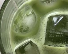 a blender filled with liquid and ice cubes