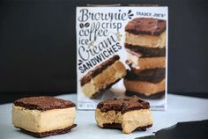 two pieces of cake sitting next to a box of brownie cheesecake sandwiches