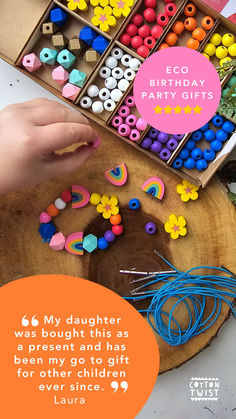 a child's hand reaching for beads in an open box with the words eco birthday gifts on it