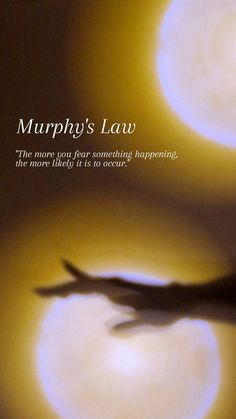 there is a shadow of a person in front of two circles with the words murphy's law on it