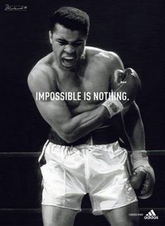 a man with boxing gloves on his chest and the words impossible is nothing written in front of him