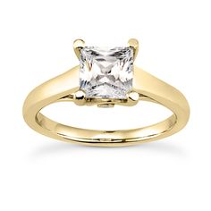 a yellow gold ring with a princess cut diamond