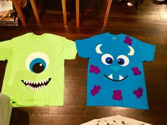 two children's t - shirts with monster faces on them sitting on the floor