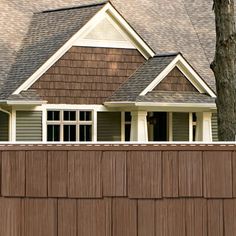 a house with brown shingles and white trim