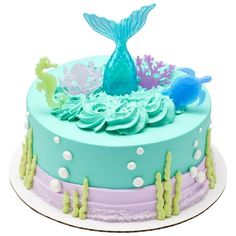 a blue and green cake with sea animals on it