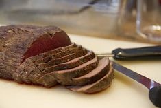 the meat is sliced up and ready to be served on the cutting board for consumption