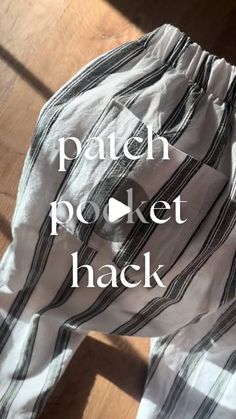 a pair of pants with the words patch pocket hack printed on them, sitting on a wooden floor