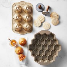 an assortment of pastries on a marble countertop with cookie molds and icing