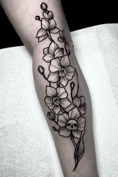 a black and white flower tattoo on the leg