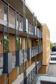 an apartment building with balconies and plants on the balconies