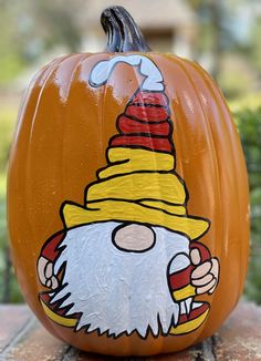 a painted pumpkin sitting on top of a table