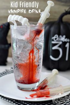 a glass filled with liquid and toothbrushes on top of a white plate