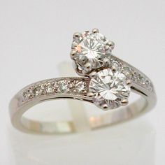 an engagement ring with two diamonds on it