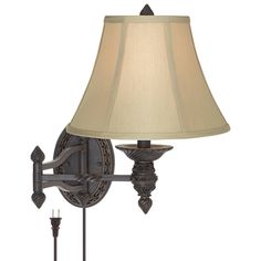 a lamp that is on the wall next to a light fixture with a beige shade