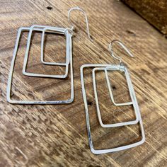 These unique earrings are made with recycled sterling silver minimizing environmental impact. 2.25'' long x 1'' wide Modern Hypoallergenic Sterling Silver Jewelry, Elegant Rectangular Sterling Silver Hoop Earrings, Elegant Sterling Silver Rectangular Hoop Earrings, Modern Sterling Silver Jewelry With Matching Earrings, Modern Sterling Silver Jewelry Set With Earrings, Minimalist Handmade Rectangular Jewelry, Modern Silver Hypoallergenic Linear Earrings, Modern Hypoallergenic Silver Linear Earrings, Modern Oblong Sterling Silver Earrings