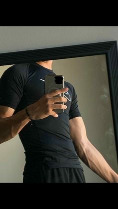 a man taking a selfie in front of a mirror