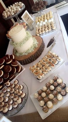 a table topped with lots of cakes and desserts