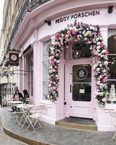 the front entrance to peggy porshen florist with pink and white flowers