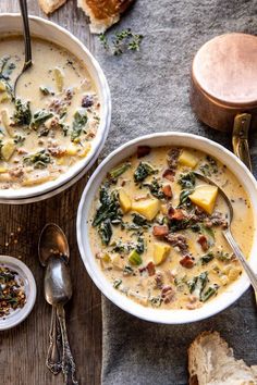 two bowls of soup with bread on the side