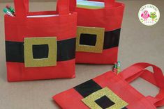 two red bags with black and gold designs on them, one has an owl in it