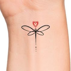 a small dragonfly tattoo with a heart on it's back side ankle bracelet