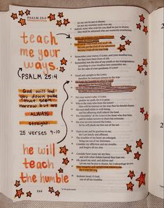 an open bible with orange and red stars on the page, which reads teach me your ways