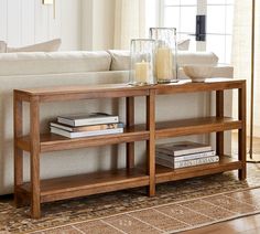 a coffee table with books and candles on it