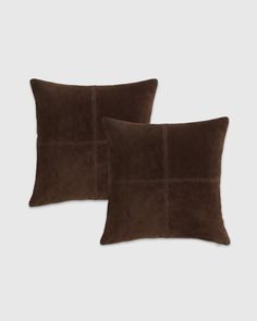 two brown velvet pillows with squares on the front and back, one in dark brown