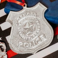 a police badge sitting on top of a black and white checkered blanket