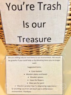 a sign that says you're trash is our treasure in front of a basket